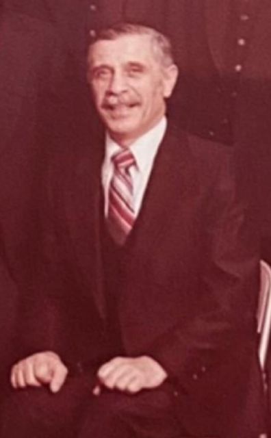 Portrait of YoungPa, seated, in a suit.
