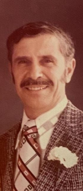 Head-and-shoulders portrait of YoungPa in a tweed jacket and tie.